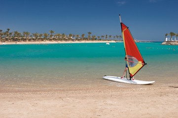 sunny beach and windsurfing board