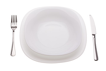 Set of plates with tablewares on white background