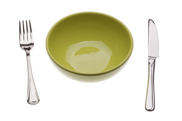 Green plate with tablewares on white background