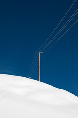 Power supply on snowy hill
