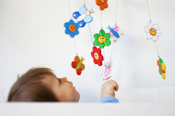 Baby playing in a crib