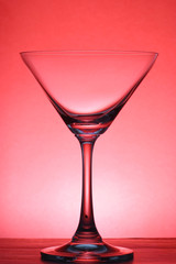 Cocktail glass in silhouette over red background