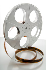 Vintage movie film and reel on white