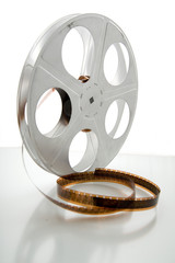 Obraz premium Vintage movie film and reel on white