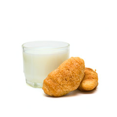 Glass with milk and cakes on plate