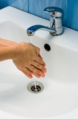 Washing hands in bathroom