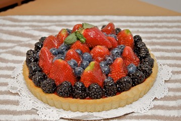 Fresh fruit tart glazed with sweetened gelatin.