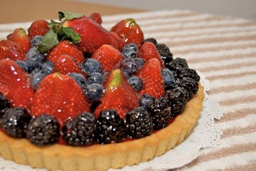 Fresh fruit tart glazed with sweetened gelatin.