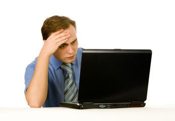 Young businessman working on a laptop. Isolated on white.