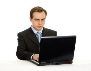 Young businessman working on a laptop. Isolated on white.