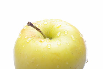 Closeup of yellow delicious apple on white