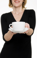 Woman in black dress offering tea/coffee