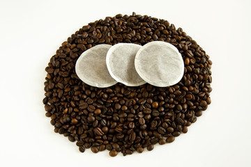 Coffee pads ontop of coffee beans