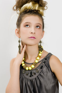 Fashion girl showing jewels and handbag