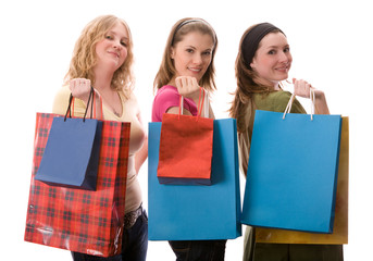 Three beautiful girls with shopping bags. Isolated on white