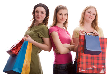Three beautiful girls with shopping bags. Isolated on white