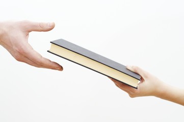 hands holding book