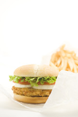 crisp chicken burger with tomato onion cheese lettuce