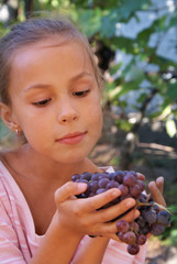 Smiling preteen girl with grapes