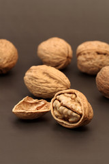 Cracked walnut with nutshell on background with walnuts