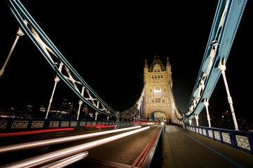 Fototapeta na wymiar Light trails at night across Tower Bridge, London