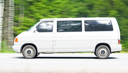white van driving a country road