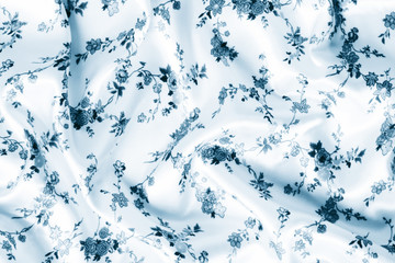 blue satin background with floral design