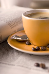 Espressotasse am morgen neben der Tageszeitung.