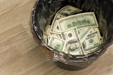 A money is in a trash bucket