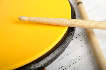 Pair of drumsticks, training pad and note paper