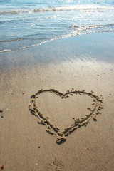 Heart drawn on sand, seacoast
