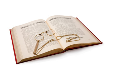 Obraz premium Vintage book and pince-nez. Isolated on white. Path included