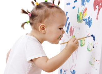 Little girl paint on a board