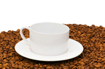 White cup on the background of coffee beans