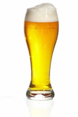 Glass of beer close-up with froth over white background