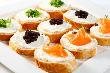 Mini sandwiches - bagel with cream cheese, salmon, caviar