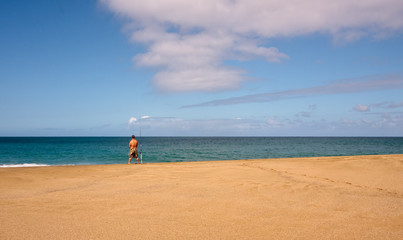 Obraz premium Sea fisherman on an empty beach
