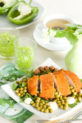 Chicken meat with pea and cup of tea