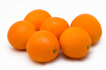 Some oranges on a white background.