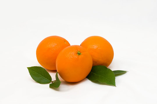 Some oranges with green leaves