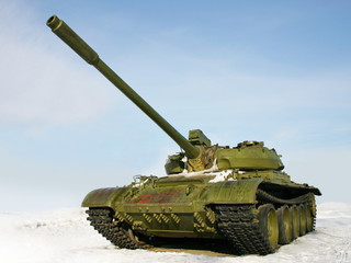 The green russian battle tank T-55 on winter background