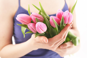 Obraz na płótnie Canvas Beautiful hands holding tulips. Soft-focused.
