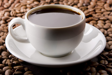 Glass Filled With Coffee on Coffee Beans