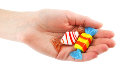 Woman's hand gives two colored candy