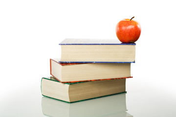 Stacked books and apple