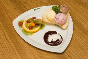 Beautiful fruit vanilla and chocolate ice cream dish.