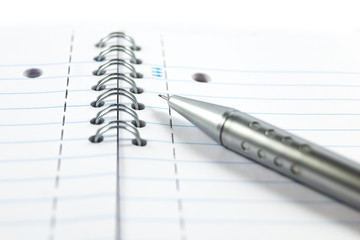 Metal mechanical pencil on a spiral-bound notepad