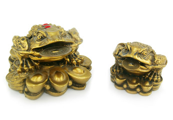 Statuette of two frogs with chinks isolated