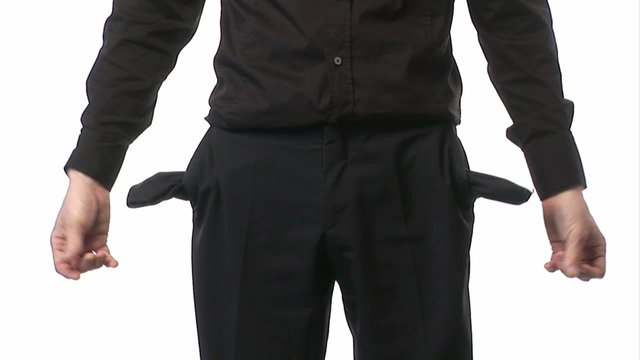 Businessman showing his pockets without money