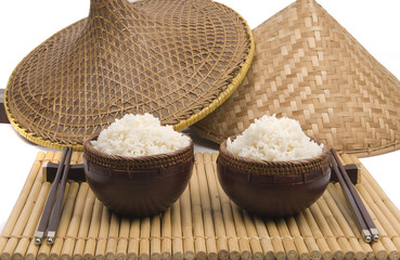 bowl of rice with oriental sticks and hats on bamboo